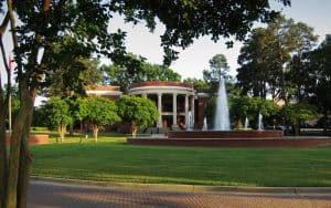 Newberry College rotunda behind a fountain on a spring day.