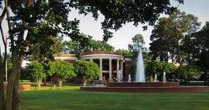 Newberry College rotunda behind a fountain on a spring day.
