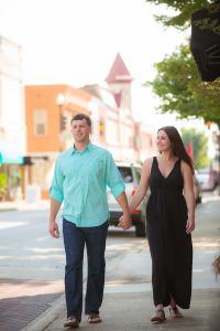 A couple strolls down the street in historic downtown Newberry